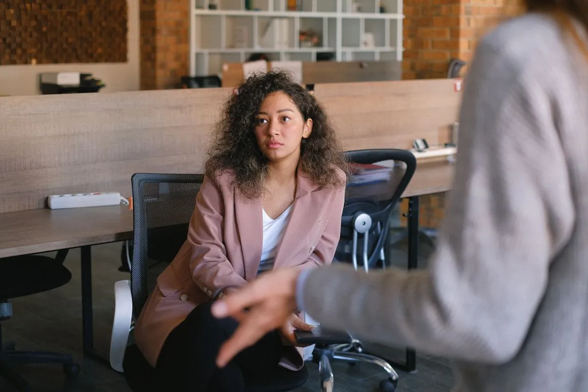 A manager listening closely to the employee opposite