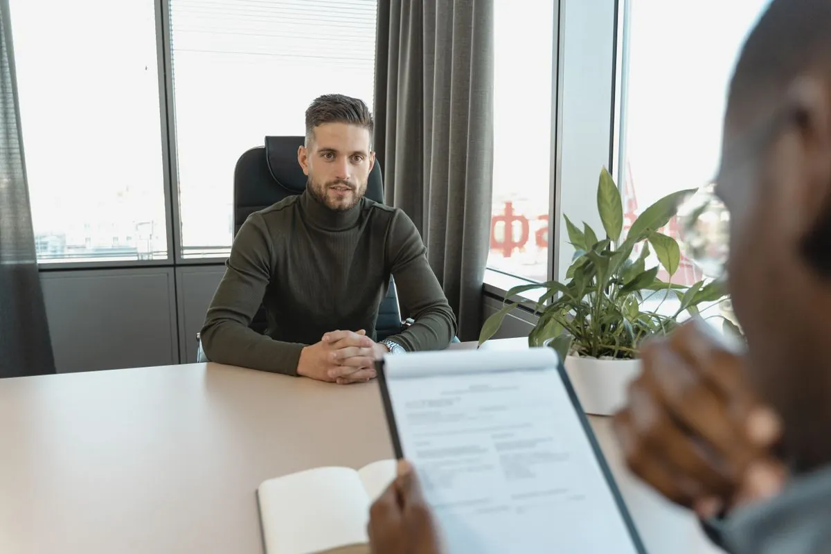 A manager interviewing a candidate at an interview table